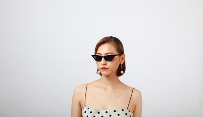 Fototapeta premium Chinese Girl wearing varies types of fashion sunglasses,looking sharp