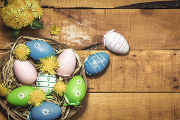 Colorful Easter eggs on wooden background