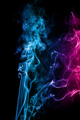 Abstract blue pink colored smoke flowed on black background.