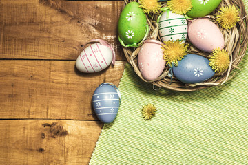 Colorful Easter eggs on wooden background