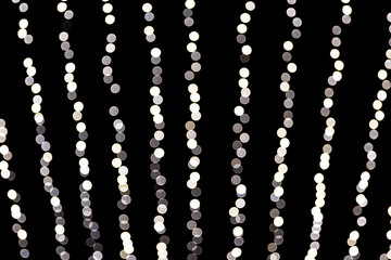 Abstract glitter sparkle bokeh defocused on black background. many round light on background
