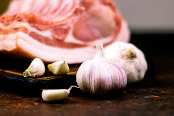 Raw fresh meat with and garlic. Raw pork rib meat on rustic brown wooden table.