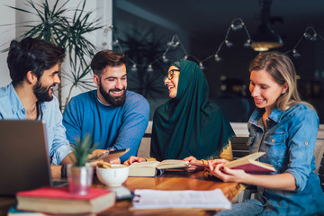 Group of students of diverse ethnic learning at home. Learning and preparing for university exam, selective focus.
