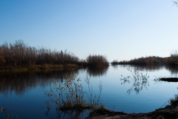 Autumn day in Arkhangelsk. Island Krasnoflotsky. the reflection in the water