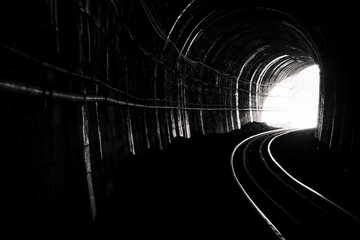 Train tunnel. Old railway in cave. Hope of life in the end of the way. Railroad of locomotive train...