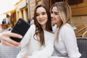 Girlfriends have fun in cafe