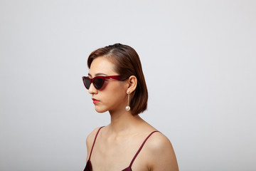 Chinese Girl wearing varies types of fashion sunglasses,looking sharp