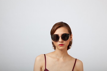 Chinese Girl wearing varies types of fashion sunglasses,looking sharp