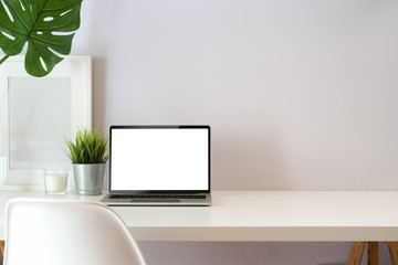 Modern creative workspace with blank screen laptop