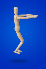 Sports wooden toy figure on blue