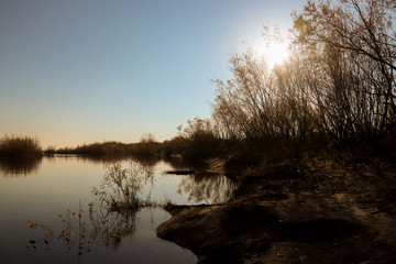 Fototapeta premium Autumn day in Arkhangelsk. Island Krasnoflotsky. the reflection in the water