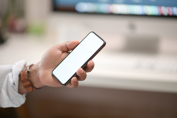 Business man showing blank screen mobile phone in office