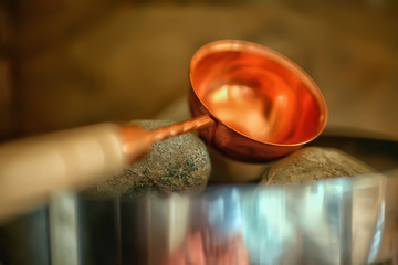sauna stones / hot stones for water supply, steam on the stones in the sauna, spa concept, hot...