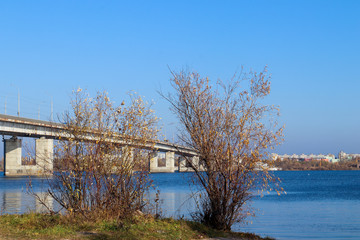 Fototapeta na wymiar Autumn day in Arkhangelsk. View of the river Northern Dvina and automobile bridge in Arkhangelsk.
