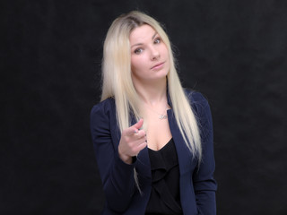 Portrait of happy smiling young cheerful businesswoman standing. Success in business concept studio shot talking to a client.