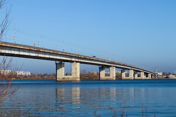 Fototapeta na wymiar Autumn day in Arkhangelsk. View of the river Northern Dvina and automobile bridge in Arkhangelsk.