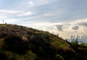 A hiker sits on a bench in Runyon Canyon staring at downtown, Los Angeles, CA.