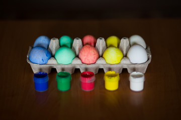 Colorful handmade easter eggs on dark background
