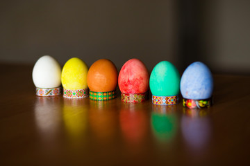 Colorful handmade easter eggs on dark background