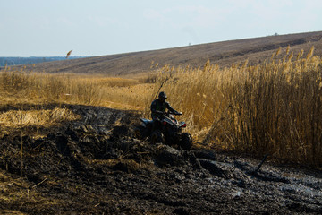 quads race on a swampy off-road track