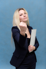 Portrait of happy smiling young cheerful businesswoman standing with folder. Success in business concept studio shot talking to a client.