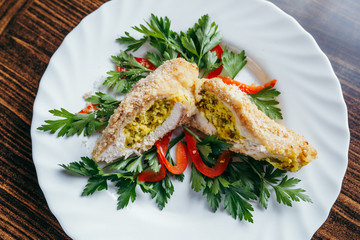 Chicken Kiev on croutons with mashed potatoes, on wooden table