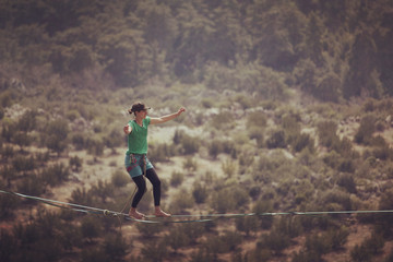 Woman balancing on the rope concept of risk taking and challenge.