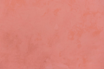 Red textured wall with stains