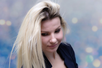 Naklejka premium Portrait of happy smiling young cheerful businesswoman standing with flowing hair. Success in business concept studio shot. Blue suit. Multicolor wall background.