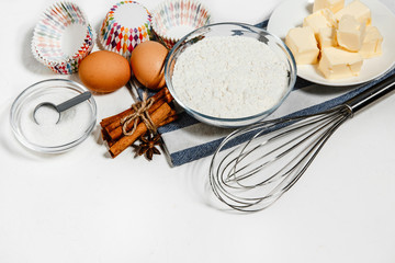 Baking background with copy space. Preparation of ingredients for dough and baking, eggs, flour and oil on white . A top view of a layout for a menu, recipe or culinary classes