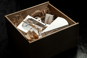 Milk chocolate with filling and cakes in a gift box tied with twine.
