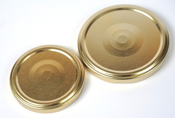 Screw caps for glass jars. For canning, canned food. Golden caps on white background