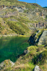 Fototapeta na wymiar blue lake with many rocks around