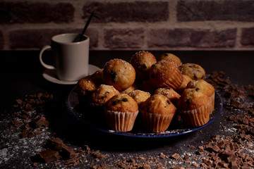 group of muffins next to a cup of milk
