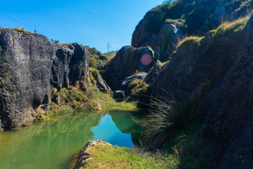 blue lake with many rocks around