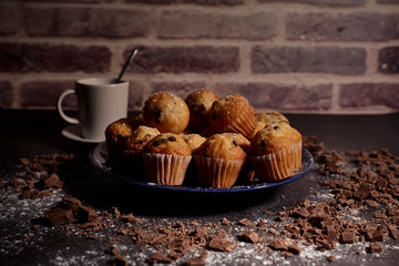 group of muffins next to a cup of milk