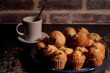group of muffins next to a cup of milk