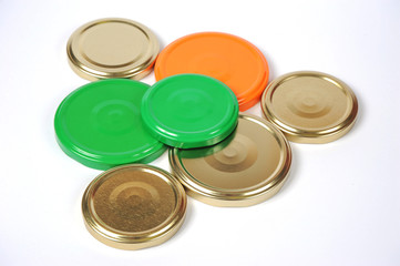 Screw caps for glass jars. For canning, canned food. Orange, green, golden caps on white background