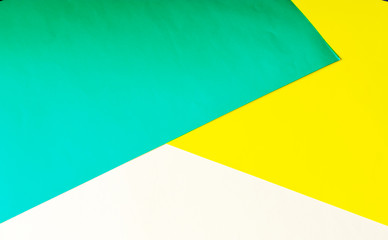 Multicolored horizontal background, colored cardboard. Yellow, green and white. Copy space