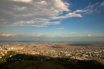A landscape view of the city of Cali, Colombia, from the top of the Hill of the Crystals, in the southern Andean mountains, at sunset.