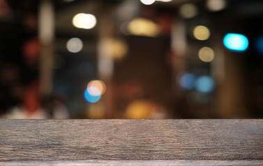 Empty dark wooden table in front of abstract blurred bokeh background of restaurant . can be used for display or montage your products.Mock up for space.