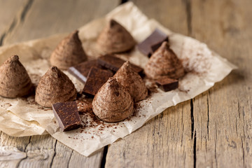 Fototapeta na wymiar Homemade Tasty Chocolate Truffle Candy on the Old Wooden Background Tasty Dessert Copy Space
