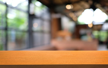 Empty dark wooden table in front of abstract blurred bokeh background of restaurant . can be used for display or montage your products.Mock up for space.