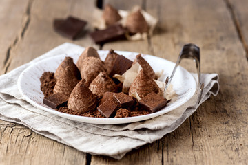 Homemade Chocolate Truffles With Cocoa Powder on a White Plate Old Wooden Background Tasty Candy Horizontal