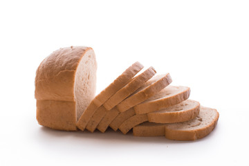 Fresh baked homemade bread and sliced bread isolated on a white background.