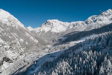 Mountain valley in winter season. Panoramic view over the forest. 