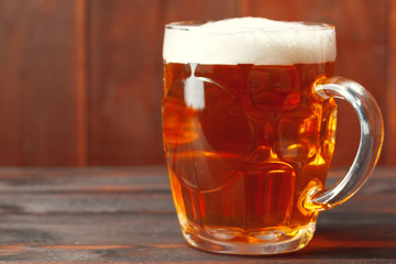 Glass beer on wood background