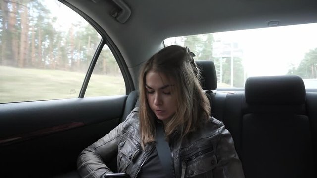 Young Woman Sitting On The Back Seat