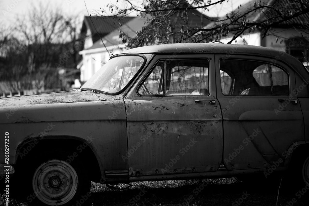 Wall mural Photo of one old car in the village