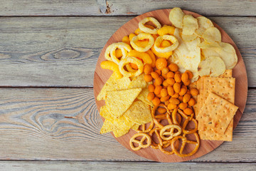 wide selection of snacks for beer on wooden background
